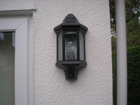 Outside light attached to white wall